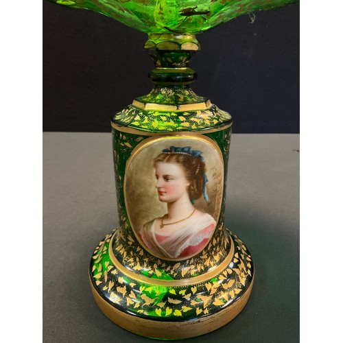 213 - A Bohemian emerald green glass comport, the cylindrical stand with painted oval portrait, decorated ... 