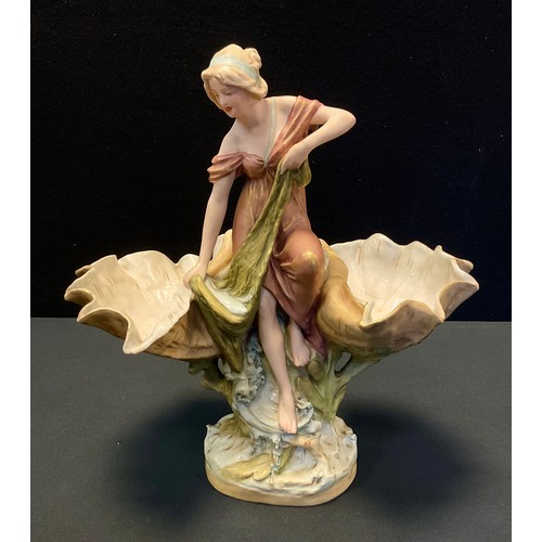 13A - A Royal Dux figural sweetmeat dish, as a classically dressed maiden between two up turned shell bowl... 