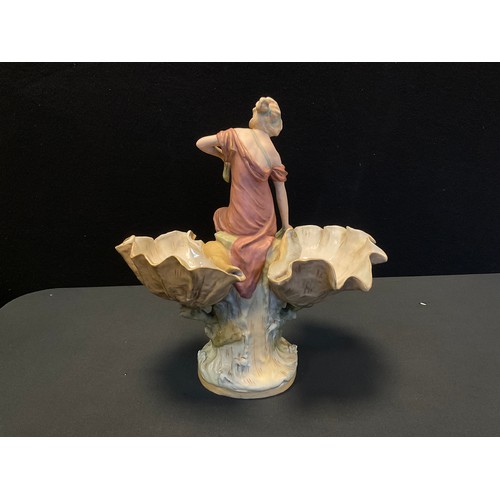 13A - A Royal Dux figural sweetmeat dish, as a classically dressed maiden between two up turned shell bowl... 