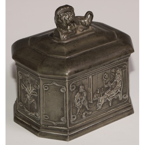 15 - A lead canted rectangular tobacco box, the sides in relief with gentlemen smoking clay pipes, the co... 