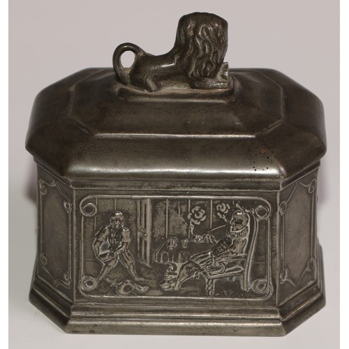 15 - A lead canted rectangular tobacco box, the sides in relief with gentlemen smoking clay pipes, the co... 