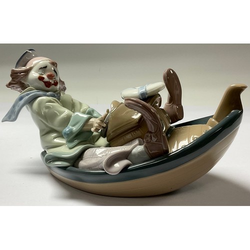 18 - A Lladro Privilege model of a youthful clown in a tug boat, number 11IX8, 24cm long, printed mark in... 