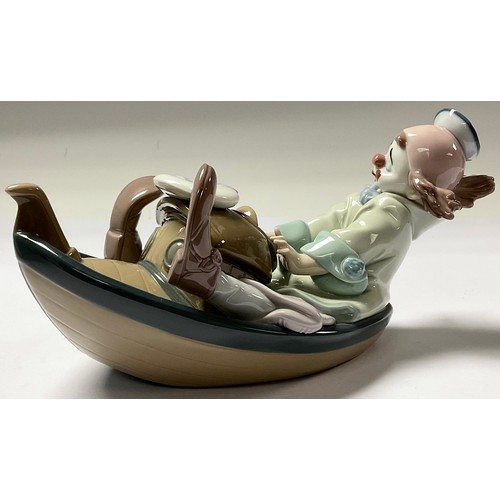 18 - A Lladro Privilege model of a youthful clown in a tug boat, number 11IX8, 24cm long, printed mark in... 