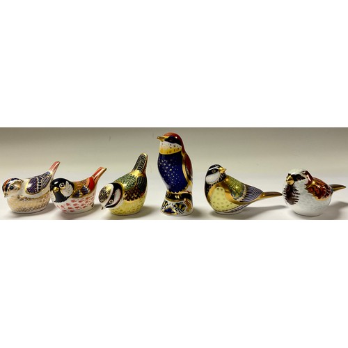 22 - A Royal Crown Derby paperweight, Bee-eater, silver stopper; others, House Sparrow, Blue Tit, Goldcre... 