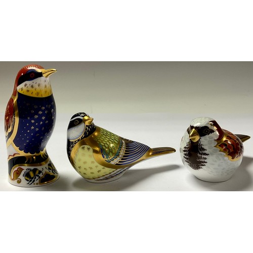 22 - A Royal Crown Derby paperweight, Bee-eater, silver stopper; others, House Sparrow, Blue Tit, Goldcre... 