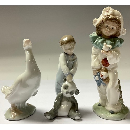 36 - A Lladro figure, boy with panda toy, First Discoveries, 14cm, number 101.06974, boxed; a Nao figure,... 