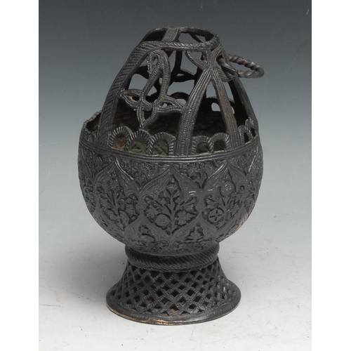 56 - An Indian dark patinated copper alloy lamp or censer, chased in the Kashmiri or Persian taste, waist... 