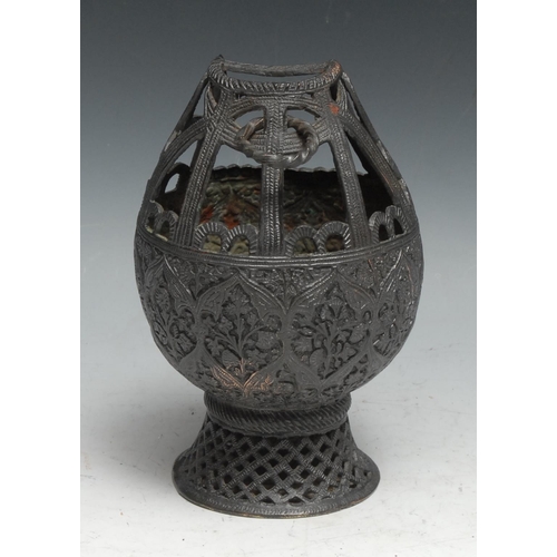 56 - An Indian dark patinated copper alloy lamp or censer, chased in the Kashmiri or Persian taste, waist... 