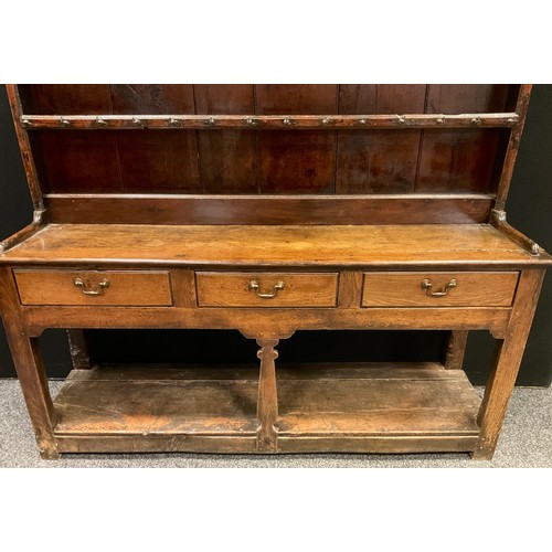 176 - A George III Oak Dresser, three tier plate rack top, with thirty nine iron hook hangers, over three ... 