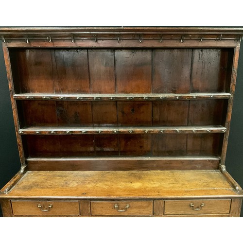 176 - A George III Oak Dresser, three tier plate rack top, with thirty nine iron hook hangers, over three ... 