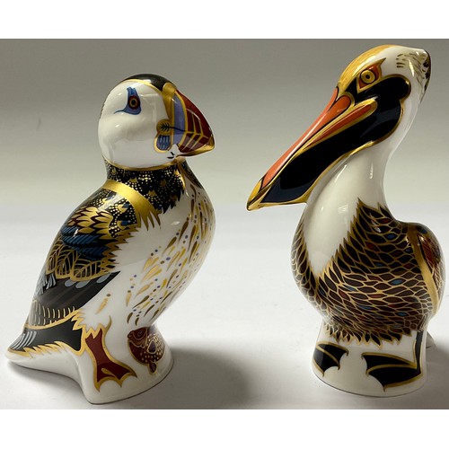 75 - A Royal Crown Derby paperweight, Penguin and Chick, silver stopper; others, Puffin, Brown Pelican, R... 