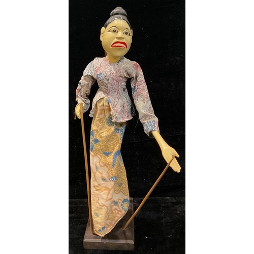 81 - An Indonesian Wayang Golek puppet, on stand, 55cm high overall