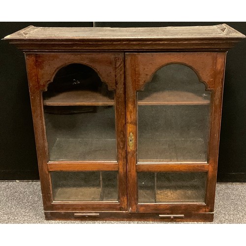 198 - A 19th century oak two door bookcase, fitted interior with two shelves above three pigeon holes, the... 