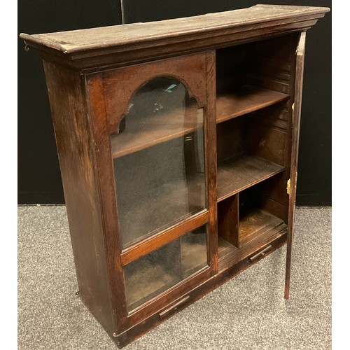 198 - A 19th century oak two door bookcase, fitted interior with two shelves above three pigeon holes, the... 