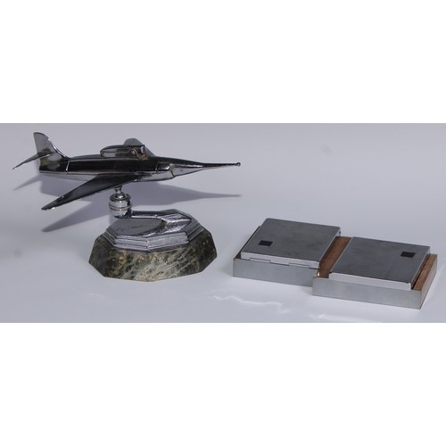 97 - A mid-20th century chrome table lighter, as a fighter jet, marble base, 24cm long; an Art Deco style... 