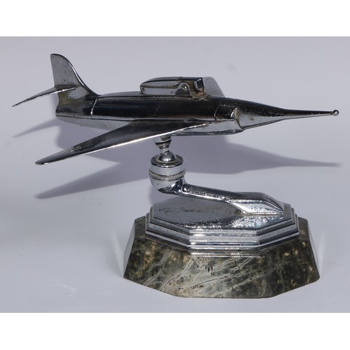 97 - A mid-20th century chrome table lighter, as a fighter jet, marble base, 24cm long; an Art Deco style... 