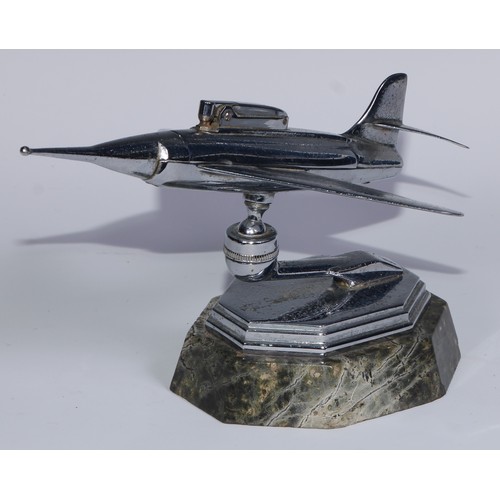 97 - A mid-20th century chrome table lighter, as a fighter jet, marble base, 24cm long; an Art Deco style... 