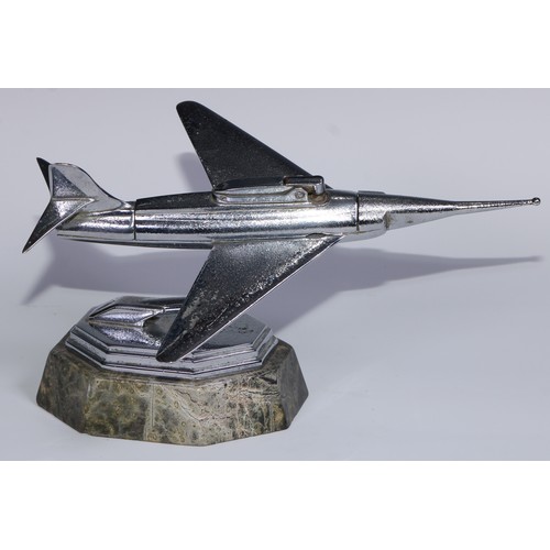 97 - A mid-20th century chrome table lighter, as a fighter jet, marble base, 24cm long; an Art Deco style... 