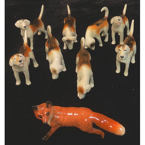 116 - A Beswick part hunting set, comprising eight foxhounds and a fox, printed marks (9)