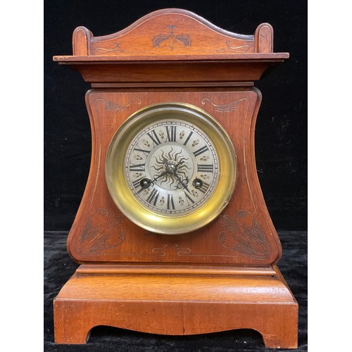 123 - A continental Art Nouveau mahogany mantel clock, arched case worked with tooled scrolling stems, sil... 