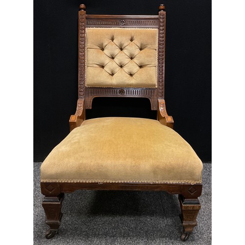 191 - A late Victorian carved oak arm chair, carved detailing, buttoned back, stuffed over seat,  upholste... 