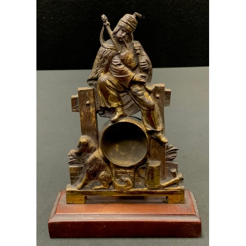 152 - A 19th century gilt metal pocket watch stand, cast as a Scottish Highlander, seated with bagpipes, h... 