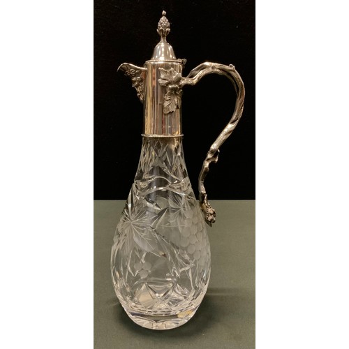 133 - An E.P.N.S mounted cut glass claret jug, cut with fruiting vine, hinged cover with bud finial, vine ... 