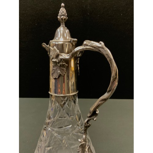 133 - An E.P.N.S mounted cut glass claret jug, cut with fruiting vine, hinged cover with bud finial, vine ... 