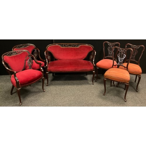 189 - An Edwardian carved mahogany salon suite, two seater sofa, pair of arm chairs, three salon chairs, e... 