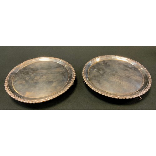 129 - A pair of early George III silver shaped circular salvers, gadrooned borders, armorial fields, hoof ... 