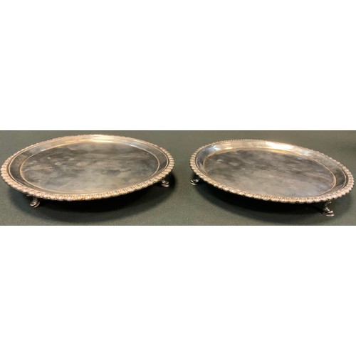 129 - A pair of early George III silver shaped circular salvers, gadrooned borders, armorial fields, hoof ... 