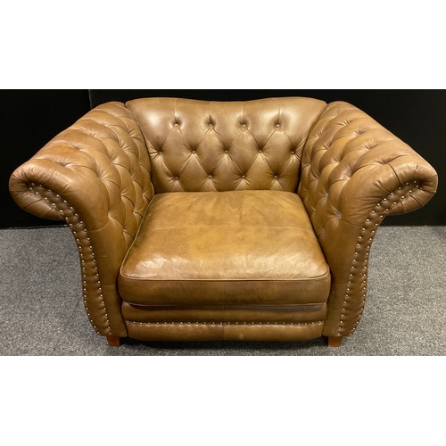 197 - A large chesterfield cuddle chair, upholstered in Persian Tobacco brown leather, block legs, Sofolog... 