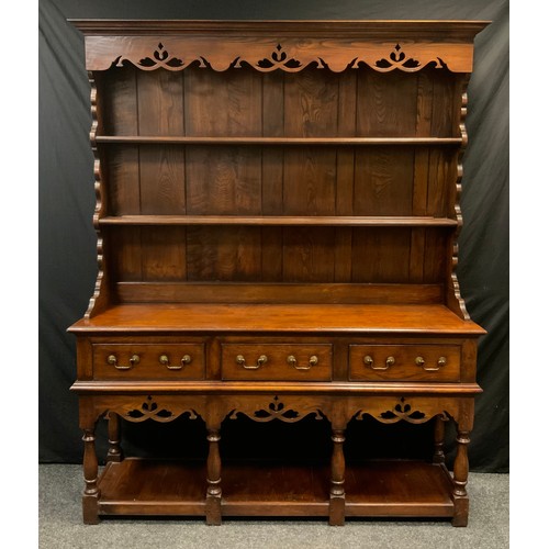 196 - A mid 20th century George III style oak dresser, shaped cornice, fretwork apron, two tiers plate rac... 