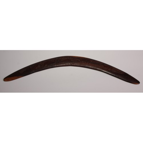 329 - An Australian Aboriginal boomerang, carved with kangaroos and emus, 55cm long