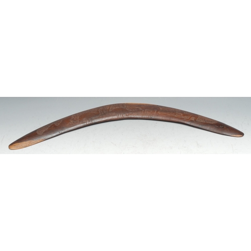 329 - An Australian Aboriginal boomerang, carved with kangaroos and emus, 55cm long