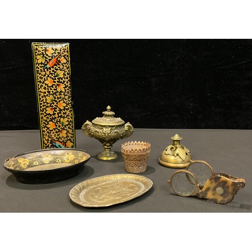 337 - A papier-mâché miniature oval tray; a coquilla nut basket; a brass inkwell, a brass desk bell, a Per... 