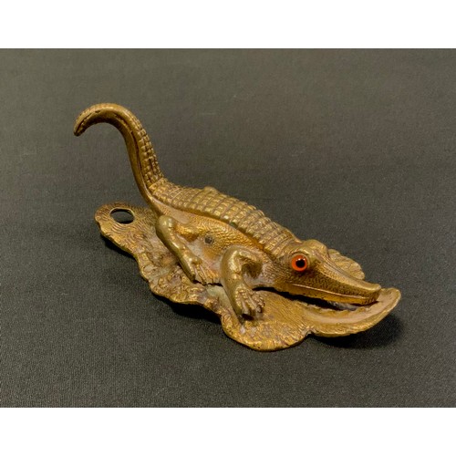 153 - A Victorian gilt brass novelty desk clip, as a crocodile, glass eyes, 12.5cm long, Rd. No. 115899, c... 