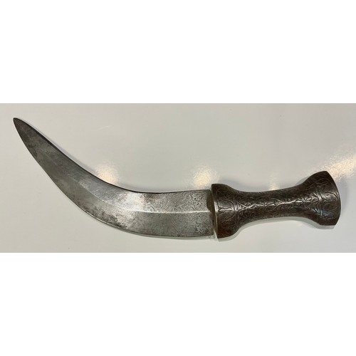 344 - An Islamic dagger, steel grip and curved blade, chased in the Islamic taste,  26cm long