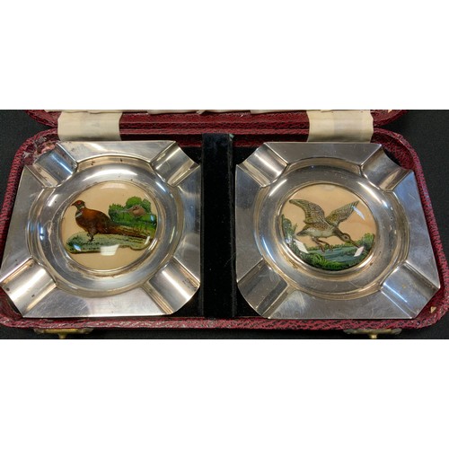 61 - A pair of E.P.N.S. canted square ashtrays, the centres with 'Essex Crystal' type intaglios, of a phe... 