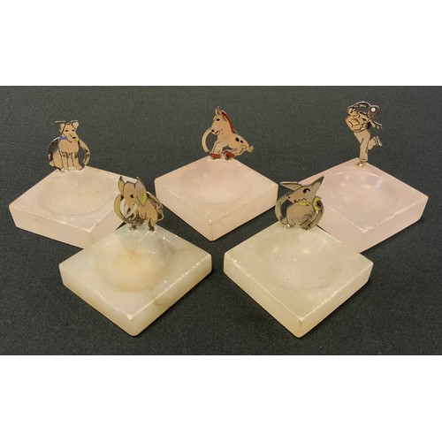 56 - A set of five Art Deco menu holders, the silver holders as dogs, elephant horse and tennis player, s... 