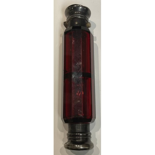 421 - A Victorian ruby glass double ended scent bottle, silver coloured metal tops, 12.5cm long