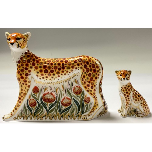 5102 - An associated pair of Royal Crown Derby paperweights, Cheetah, silver stopper, 17.5cm long, printed ... 