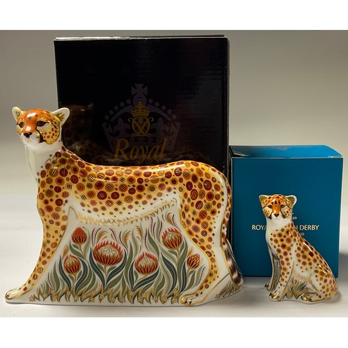 5102 - An associated pair of Royal Crown Derby paperweights, Cheetah, silver stopper, 17.5cm long, printed ... 