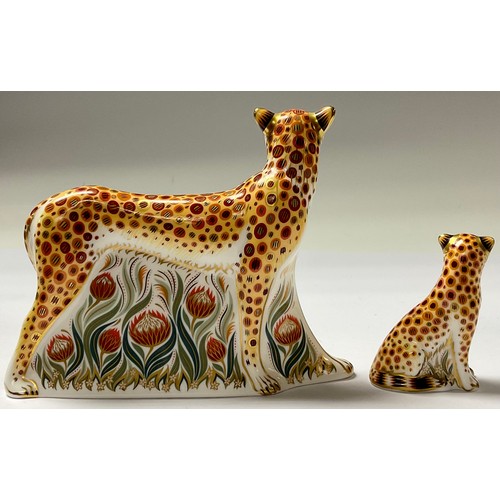 5102 - An associated pair of Royal Crown Derby paperweights, Cheetah, silver stopper, 17.5cm long, printed ... 