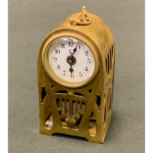 74 - A German Art Nouveau brass travelling clock, pierced with tendrils and strap work, 9.5cm high, c.191... 