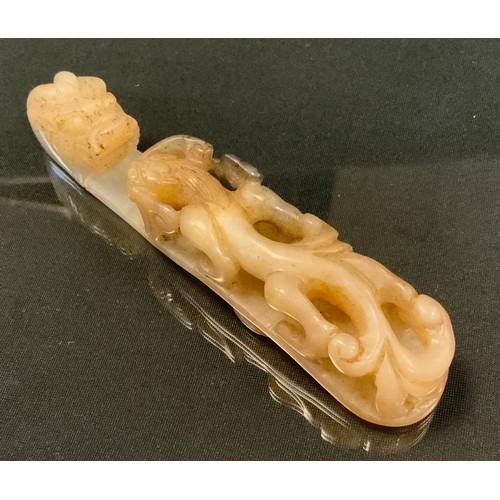 675 - A late 19th century Chinese carved cream jade belt hook, as a dragon, 12.5cm long, 2.3cm wide