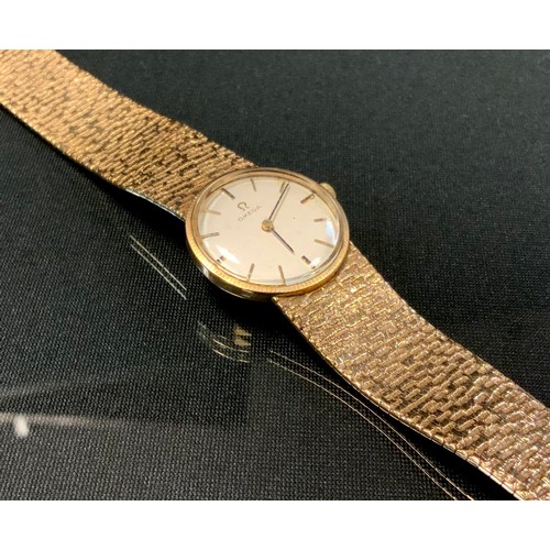 703 - Omega - a 9ct gold bracelet wristwatch, silvered dial, block baton markers, manual wind movement, se... 