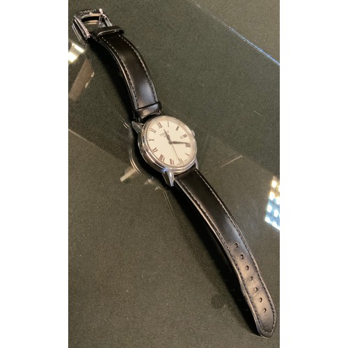 706 - Tissot -a stainless steel wristwatch, white dial, black Roman numerals, minute track, centre seconds... 