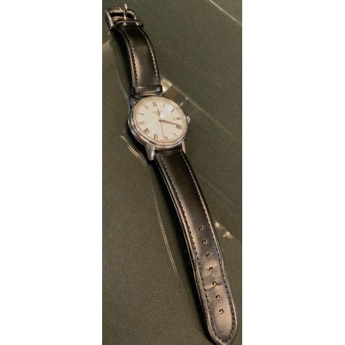 706 - Tissot -a stainless steel wristwatch, white dial, black Roman numerals, minute track, centre seconds... 