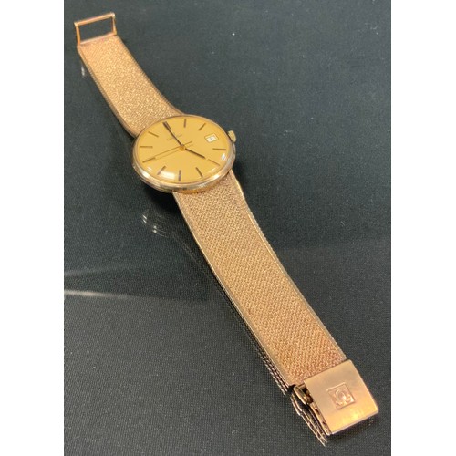 710 - Omega - a 9ct gold bracelet wristwatch, gold dial, block baton markers, date aperture, minute track,... 